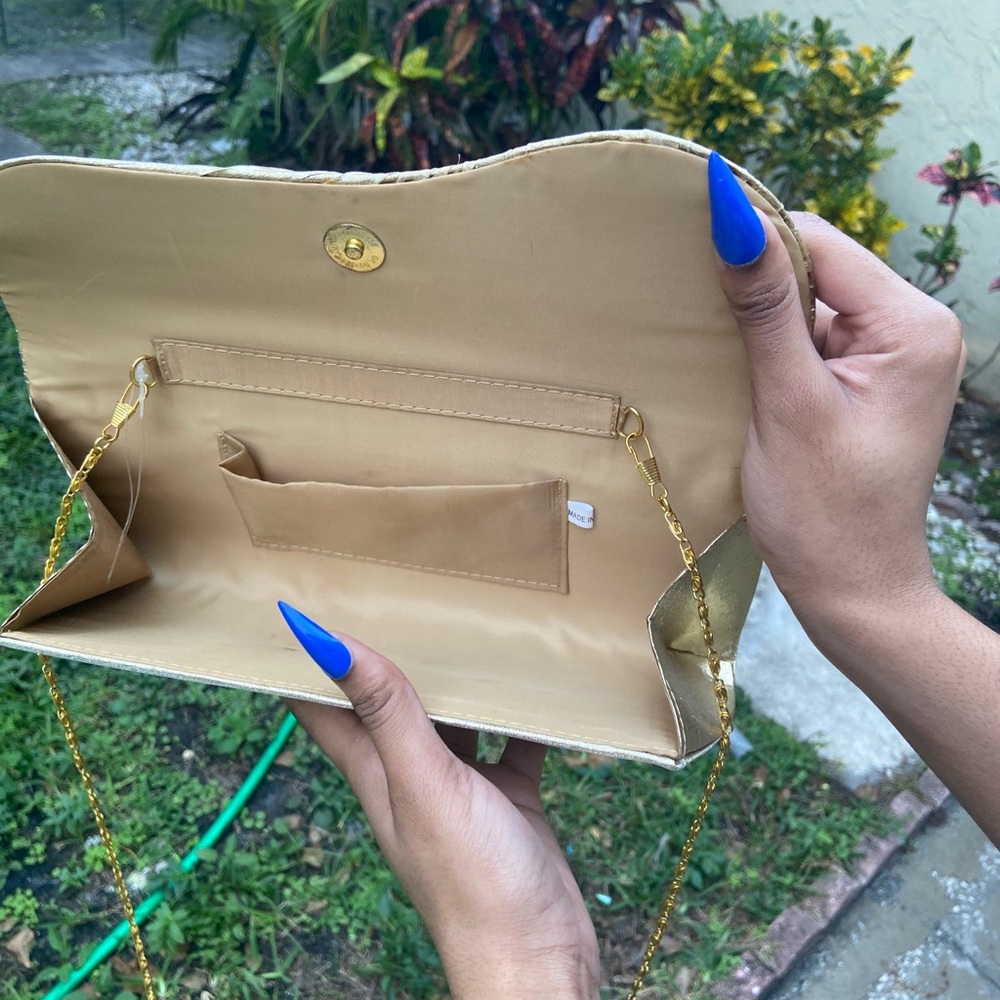 Golden crystal encrusted flower clutch.